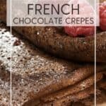 French chocolate crepes served with raspberry jam icing sugar on a plate: Pin with text.