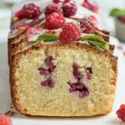 Raspberry loaf cake Ispahan sliced and served on a white serving board.
