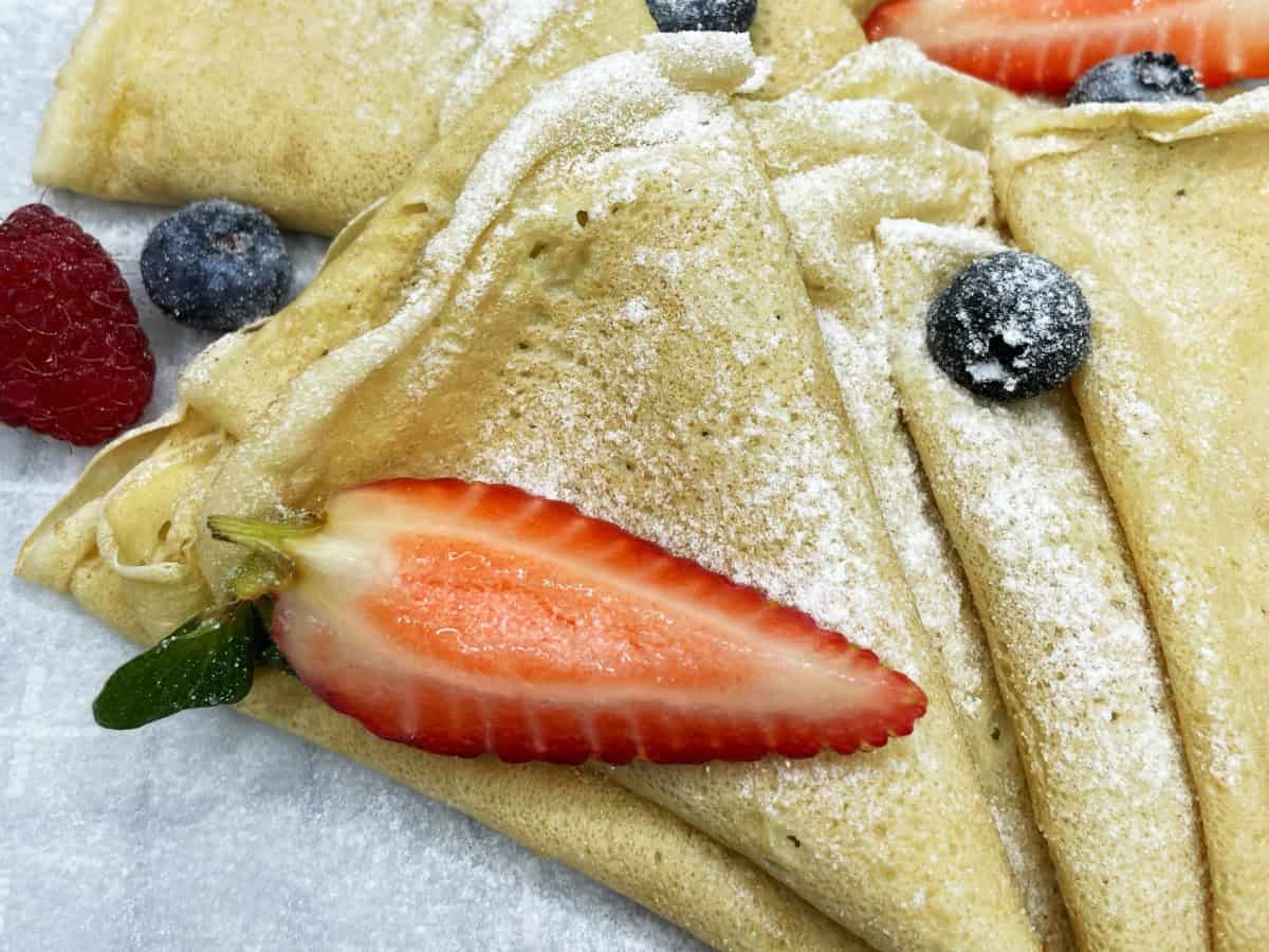 Served almond milk crepes on a plate.