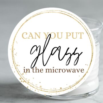 Glass of milk with text overlay: Can you put glass in the microwave.