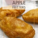 Three beignets aux pommes with an apple and a plate with apple fritters: Pin with text.