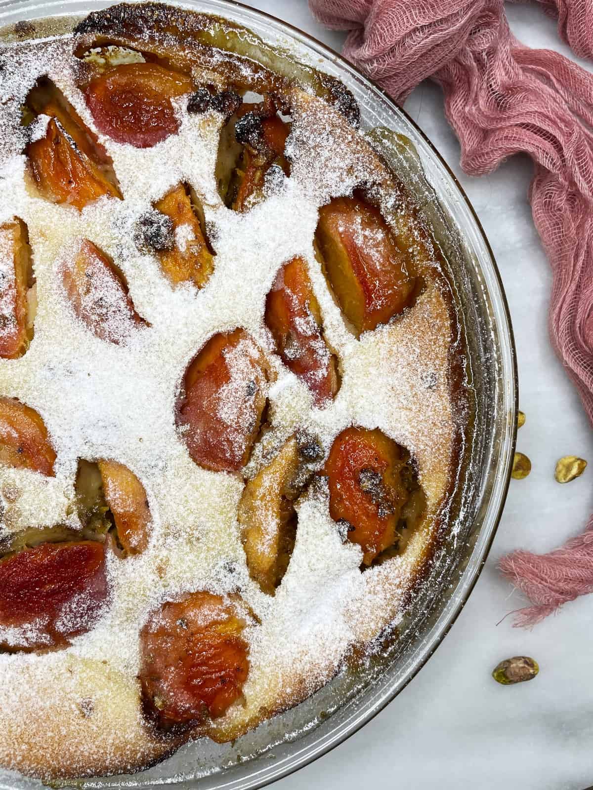 Baked peach clafoutis in a baking dish