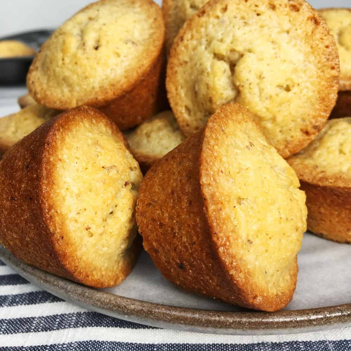 A batch of brown butter French financiers on a grey dessert plate