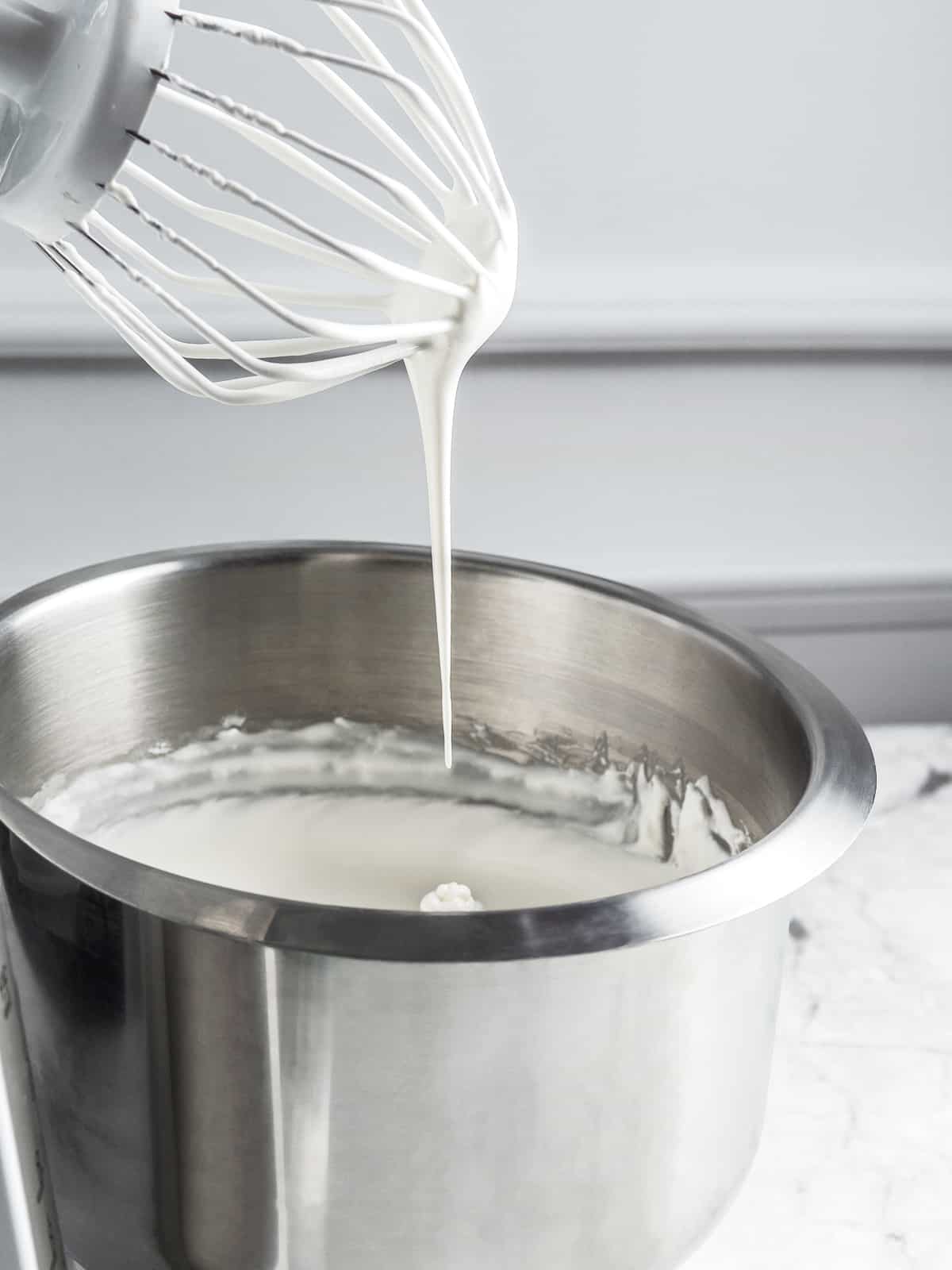 Chantilly cream with a soft peak at the tip of the whisk
