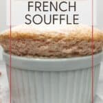 Pink-colored French souffle with crushed pink praline in the background: Pin with text.