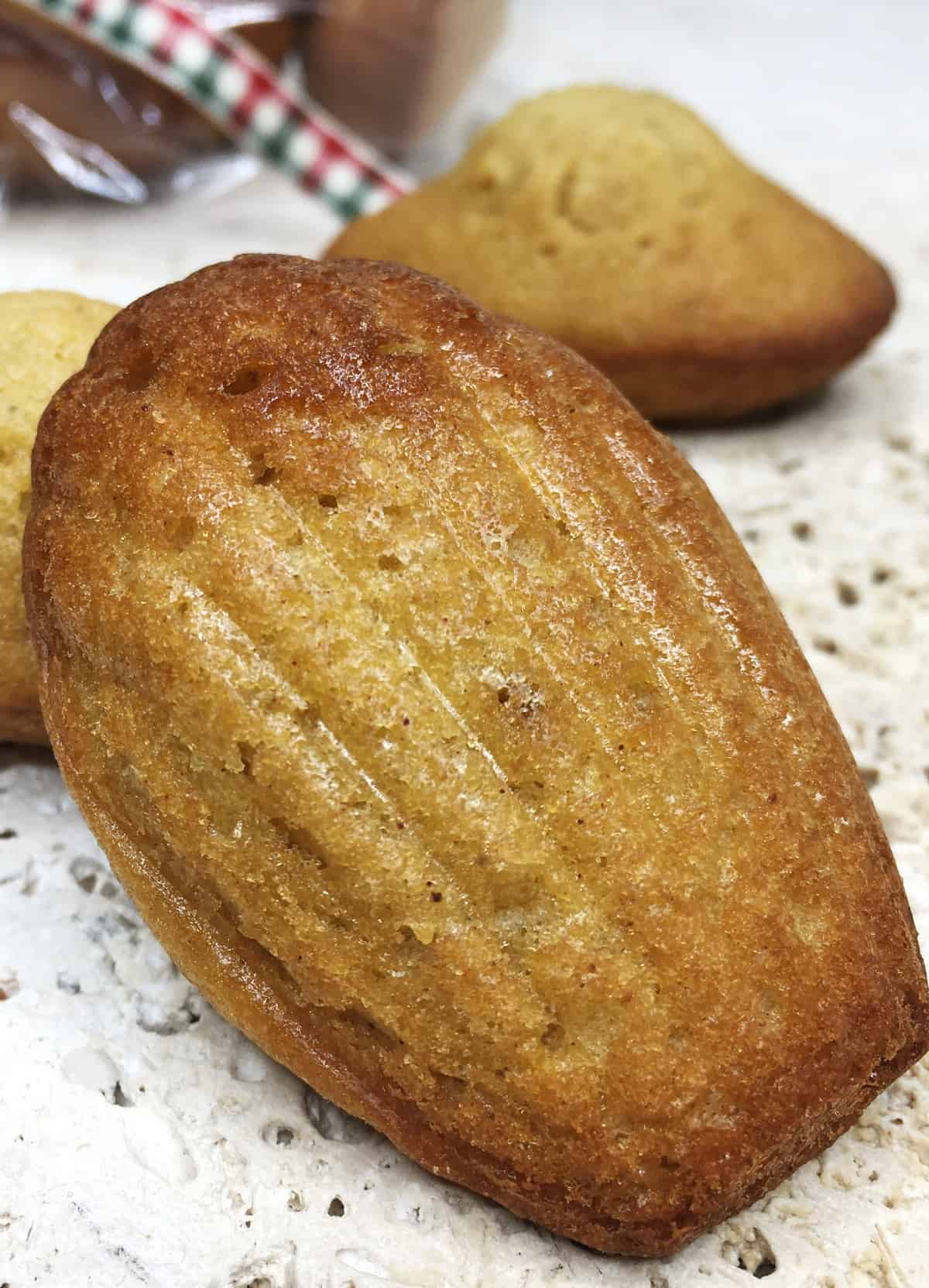 Shell sided madeleine with the rest of the gingerbread madeleines in the background