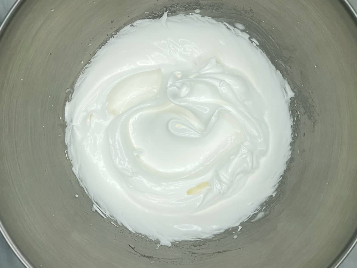 Glossy meringue icing in a mixing bowl