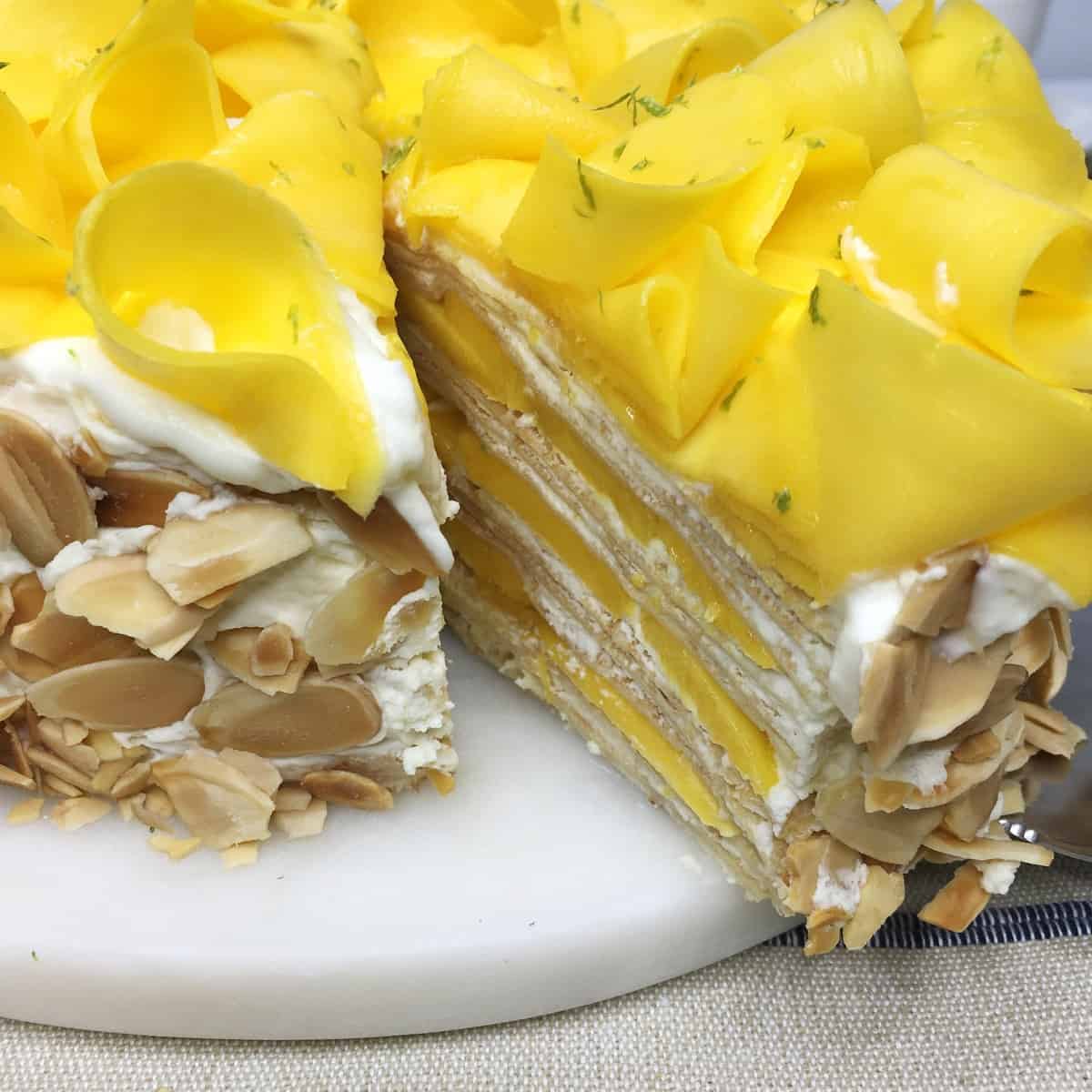 Sliced Mille crepe cake on a white marble board: Close up