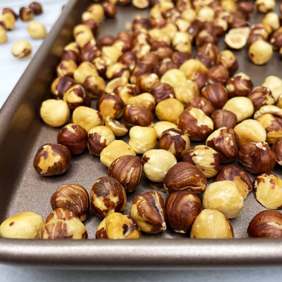 Roasted hazelnuts on a baking sheet