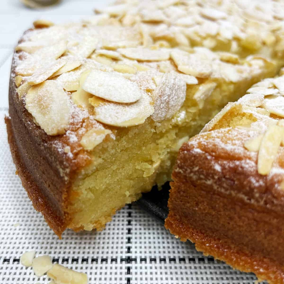 Sliced French almond cake on a pan's base 