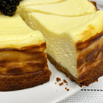 Sliced cottage cheese cheesecake on a white plate