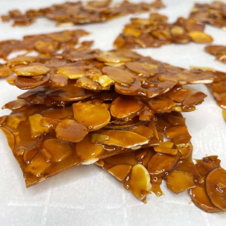 Stacked almond nougatine pieces on parchment paper
