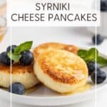 Sirniki topped with honey, blueberries, and mint leaves: Pin with text.