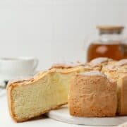 Sliced sponge apple cake on a serving board.