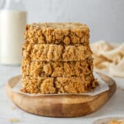 Stack of banana bread slices on a serving board.