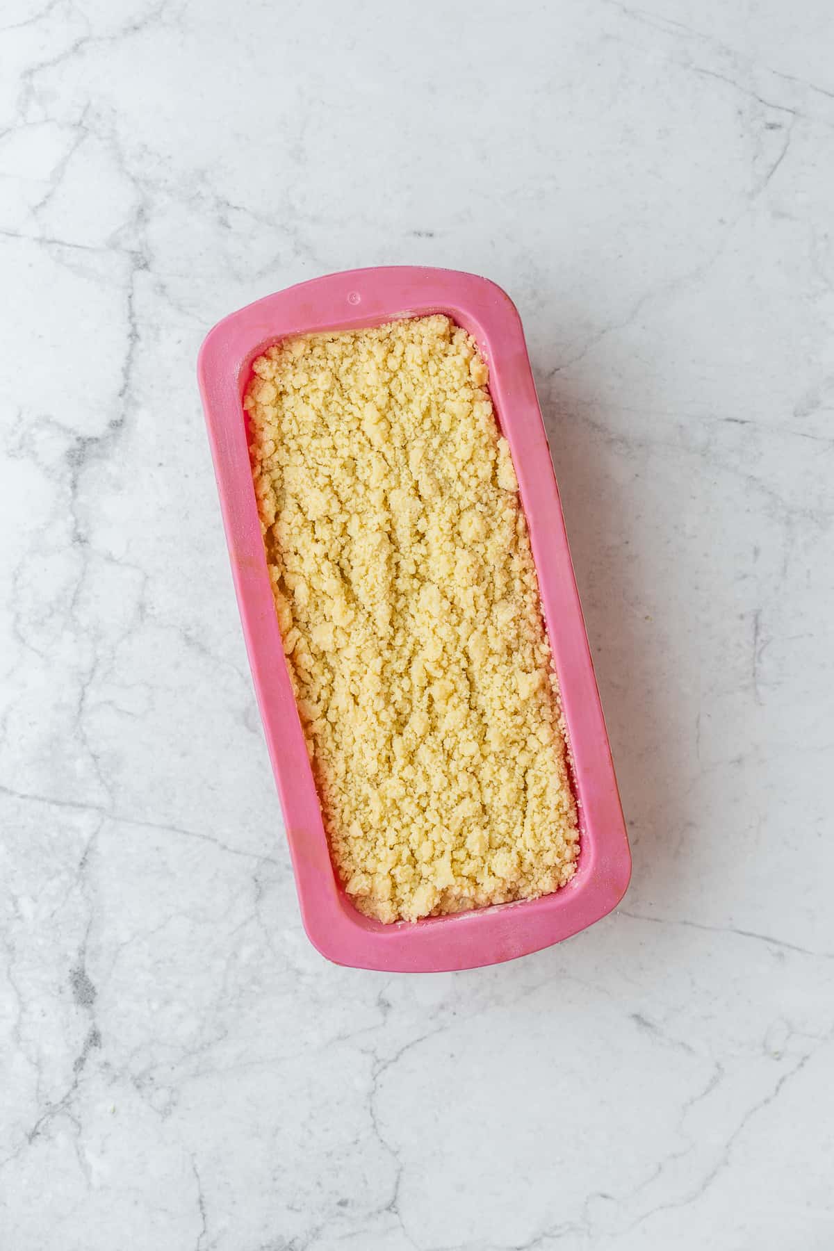 Banana bread batter in a silicone baking loaf pan.