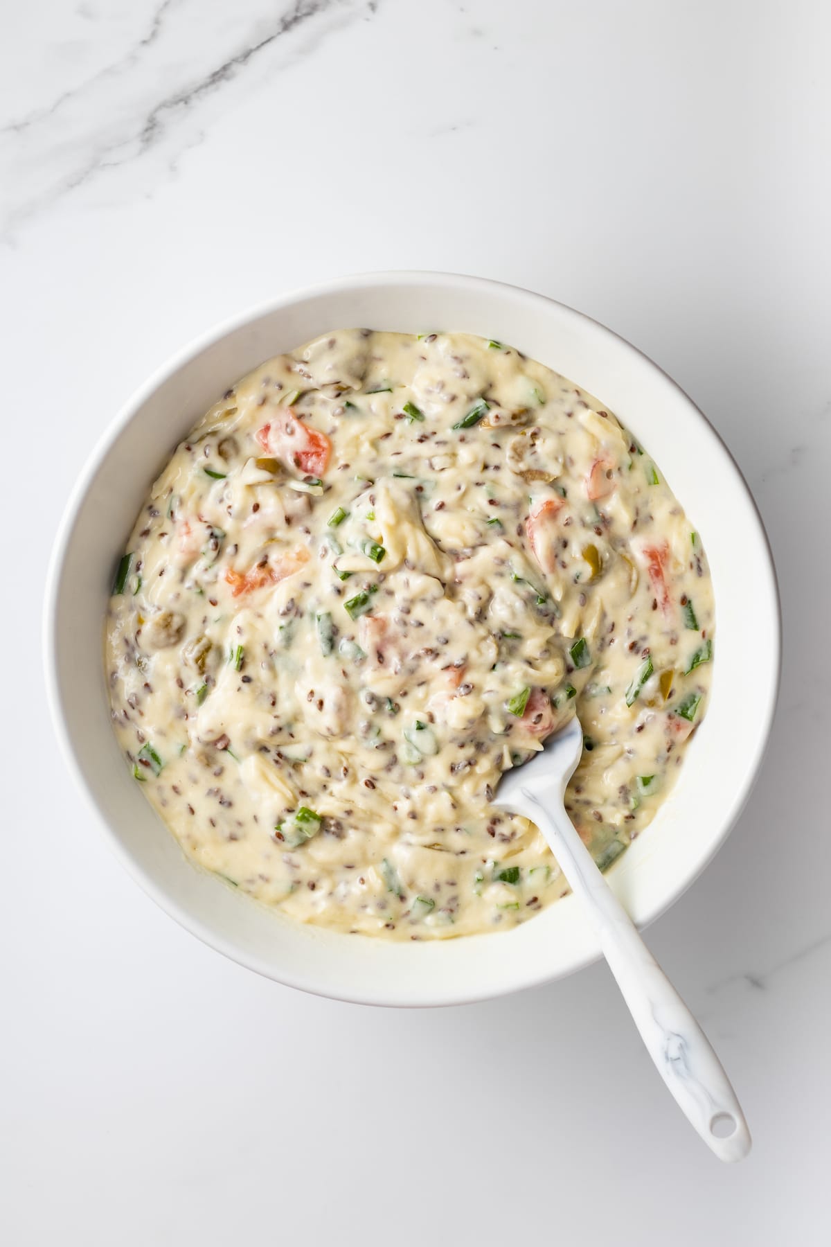 Savory cake batter with a spatula in a mixing bowl.