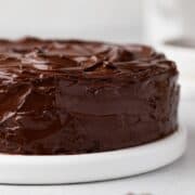 Assembled chocolate cake with chocolate ganache frosting.