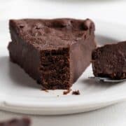 A single slice of chocolate fondant cake on a plate.