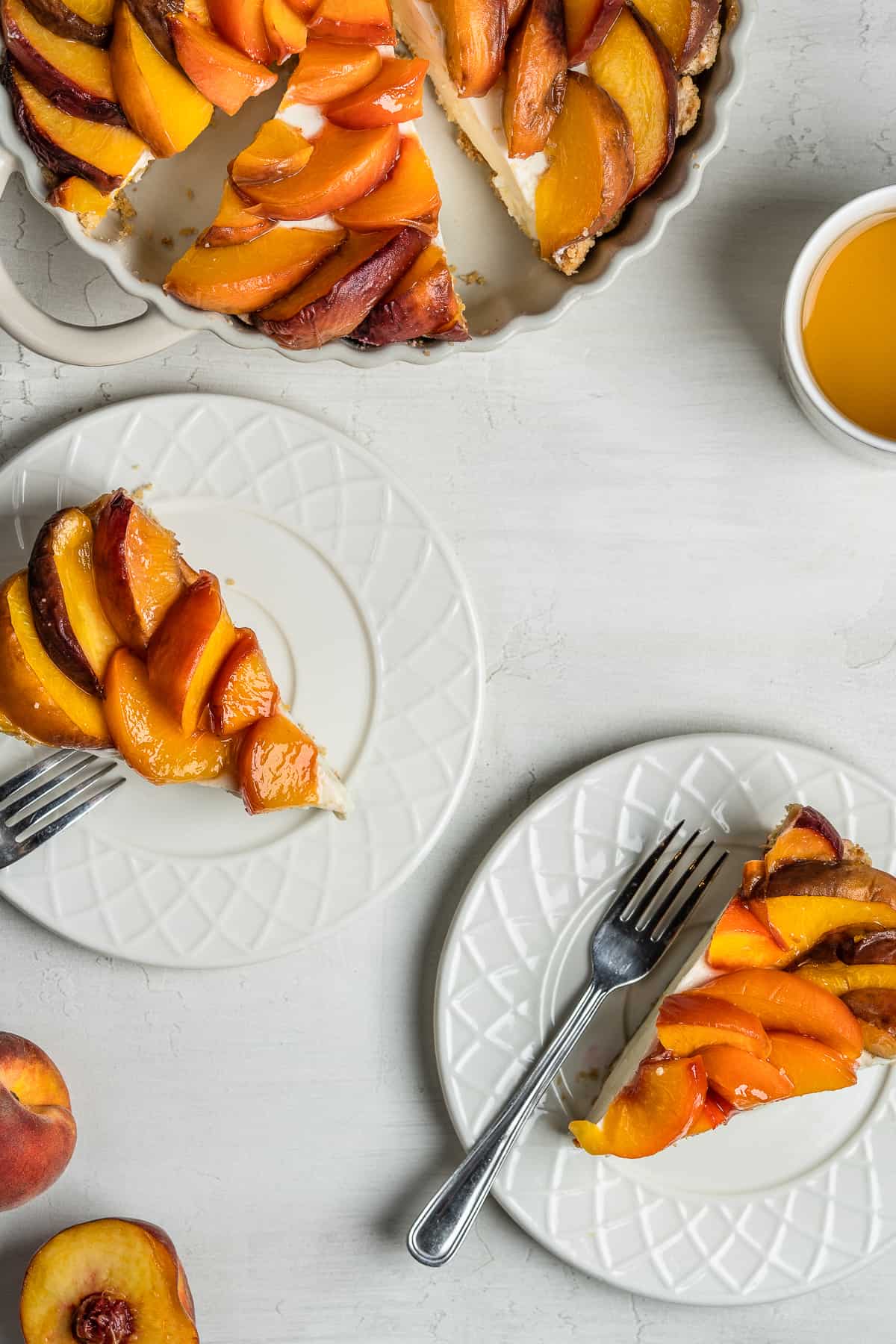 French peach tart slices on dessert plates.