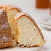 A slice of gateau de Savoie on a serving board.