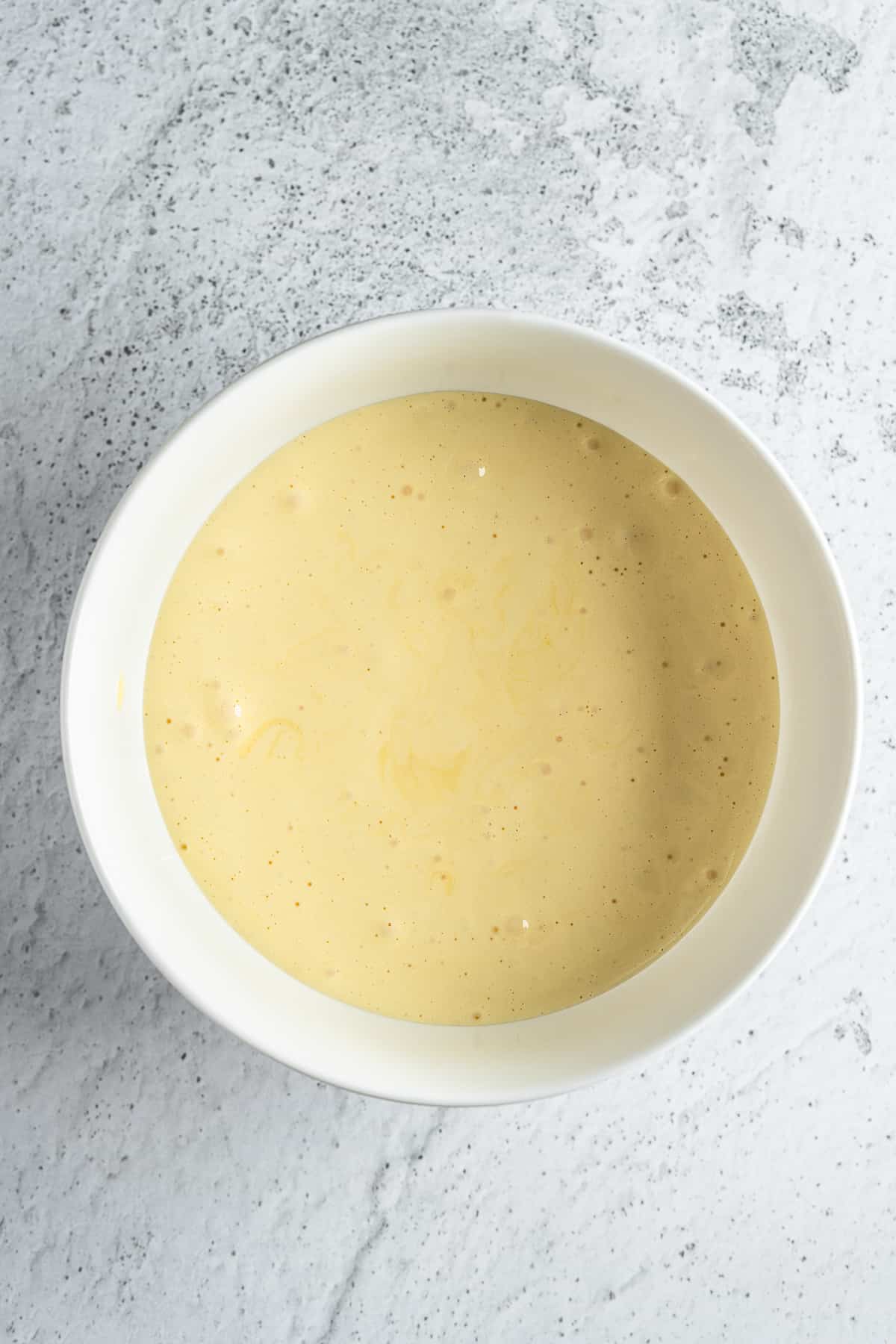 Beaten egg yolks with sugar in a bowl.
