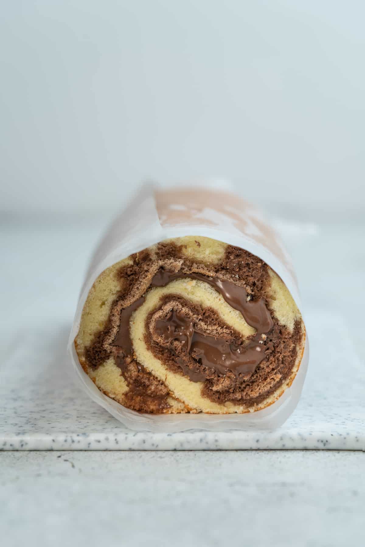 Nutella cake rolled in parchment paper.
