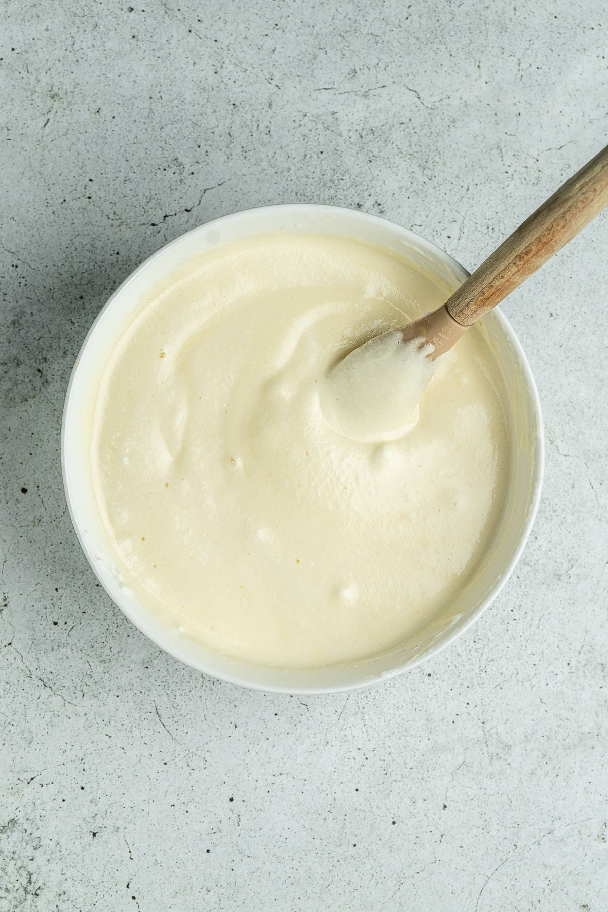 Cake batter with a spatula in a bowl.