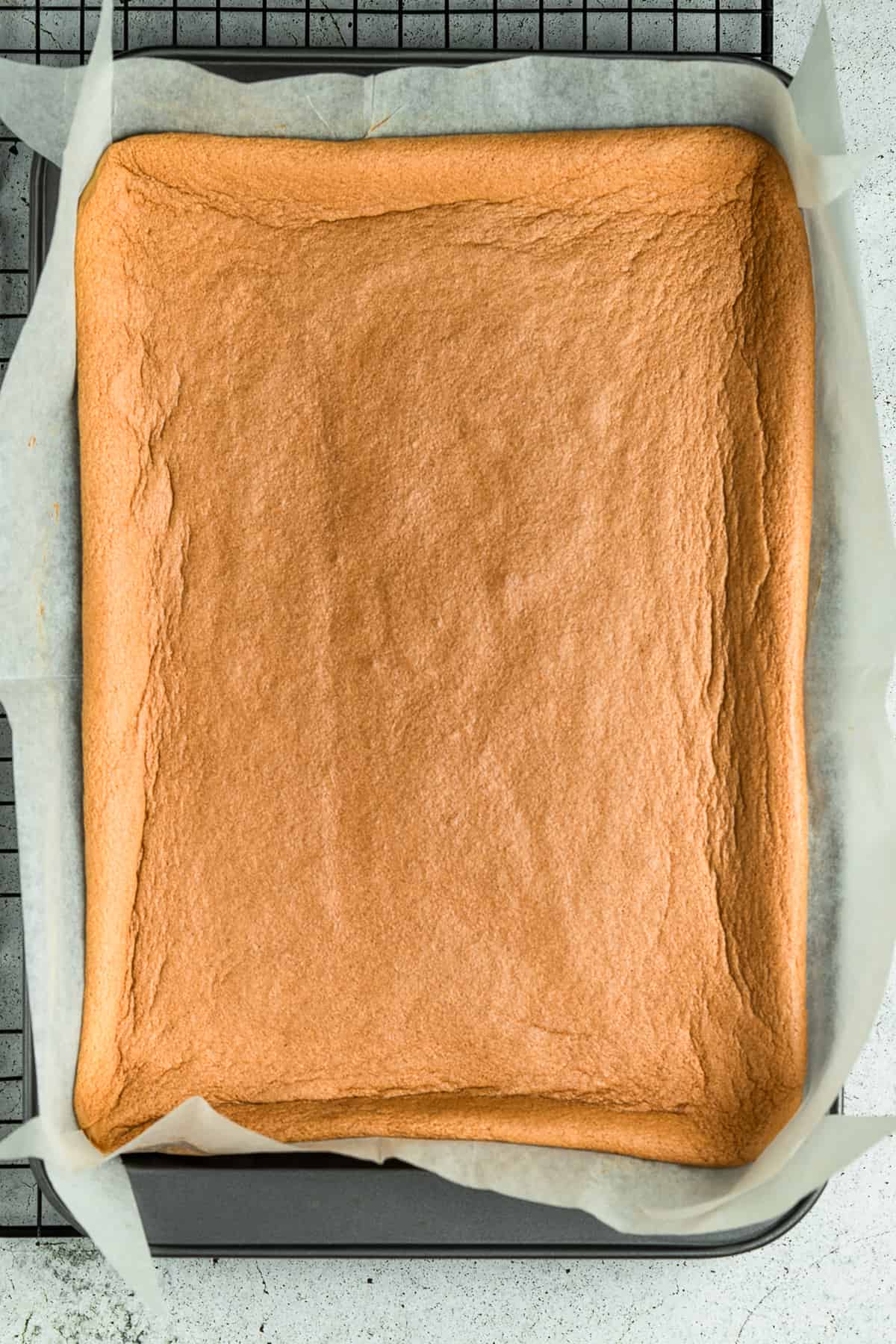 Baked cake in a Swiss roll tin.