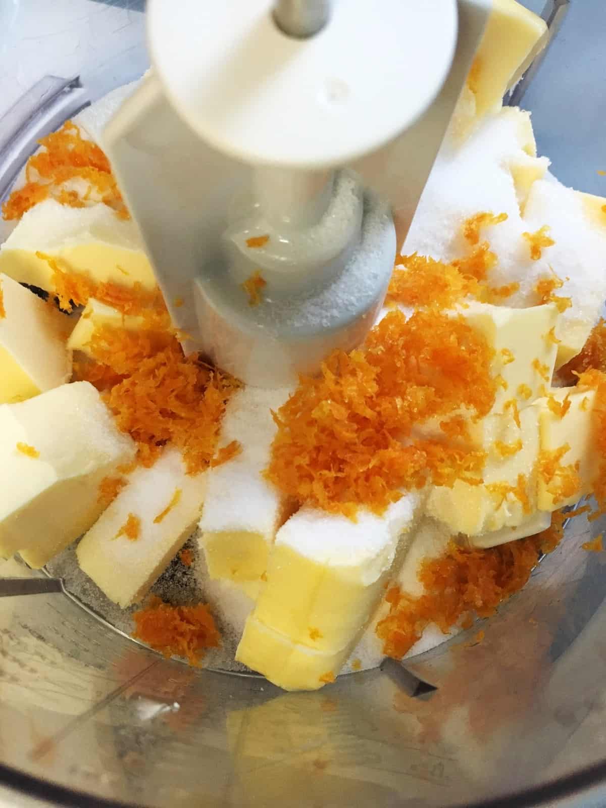 Butter, sugar, and orange zest in the bowl of a stand mixer 