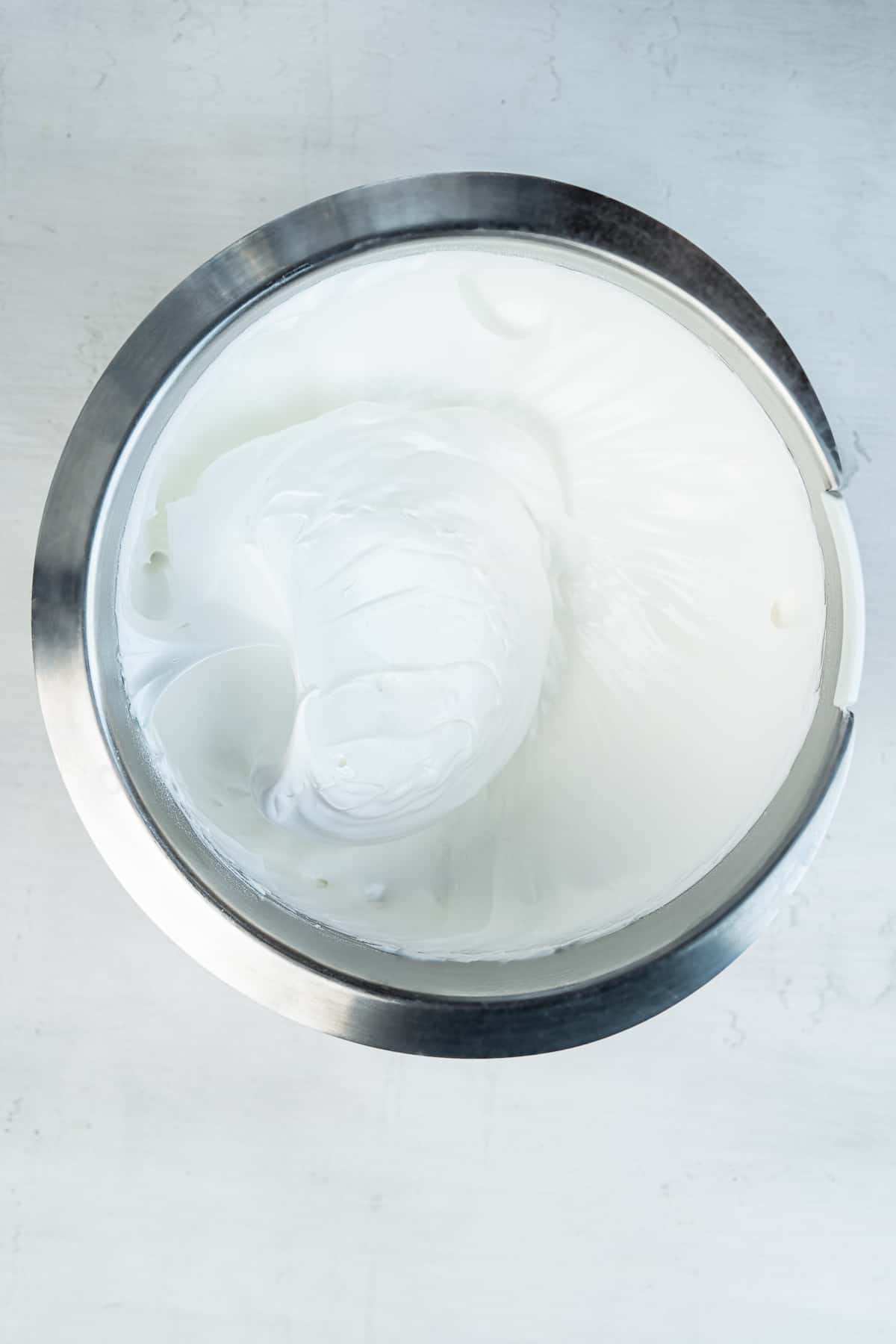 Meringue in a metal bowl.