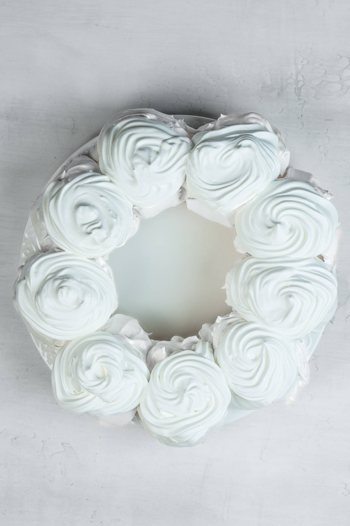 Meringue wreath topped with whipped cream.