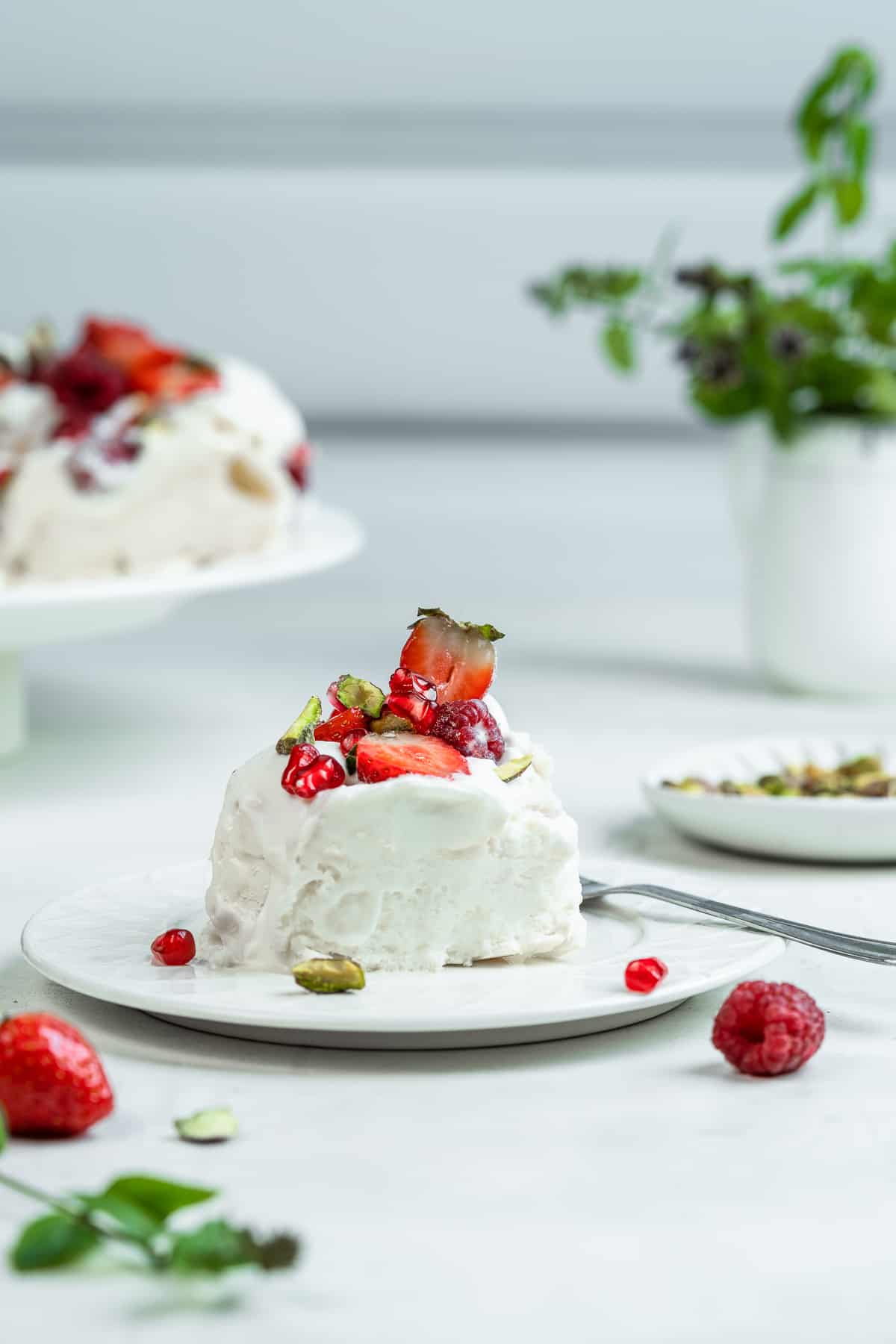 A single slice of Pavlova wreath on a dessert plate.