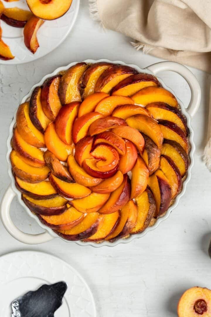French peach tart with panna cotta in a baking mold.
