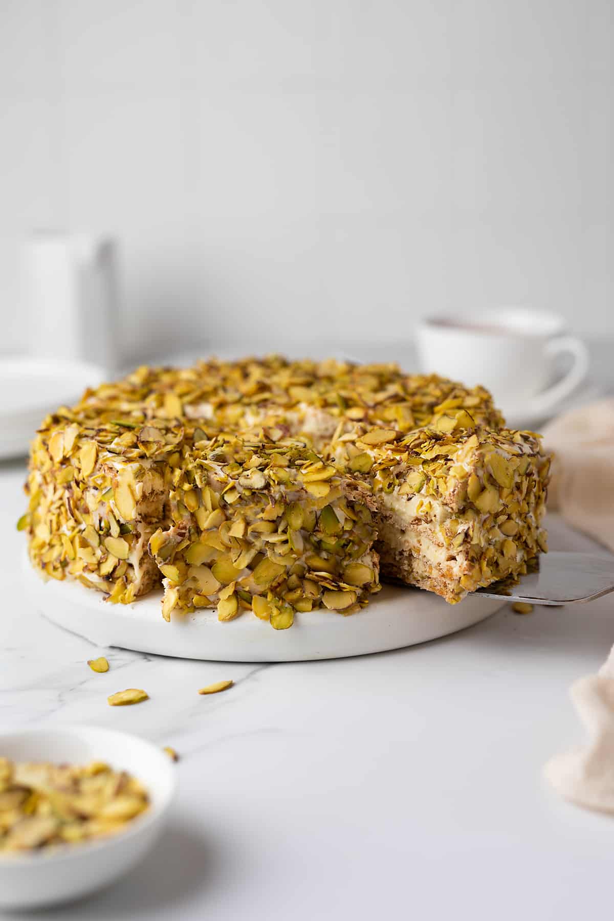 Pistachio Sans Rival on a serving board. 