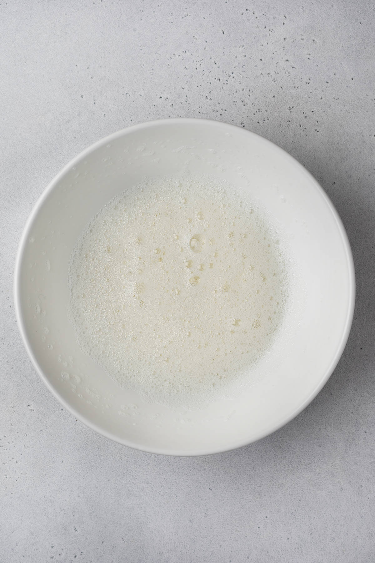 Beaten egg whites in a bowl 