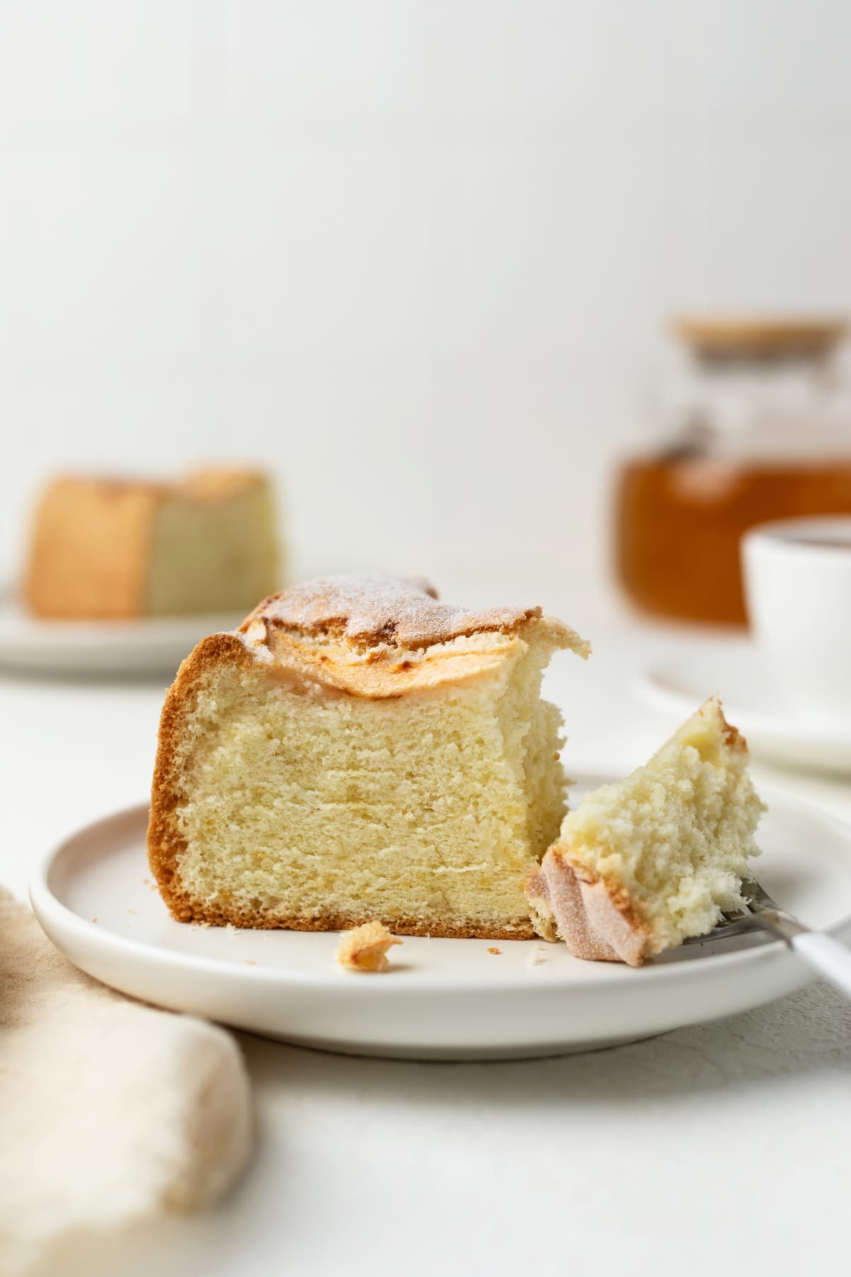 A single slice of apple sponge cake on a dessert plate.