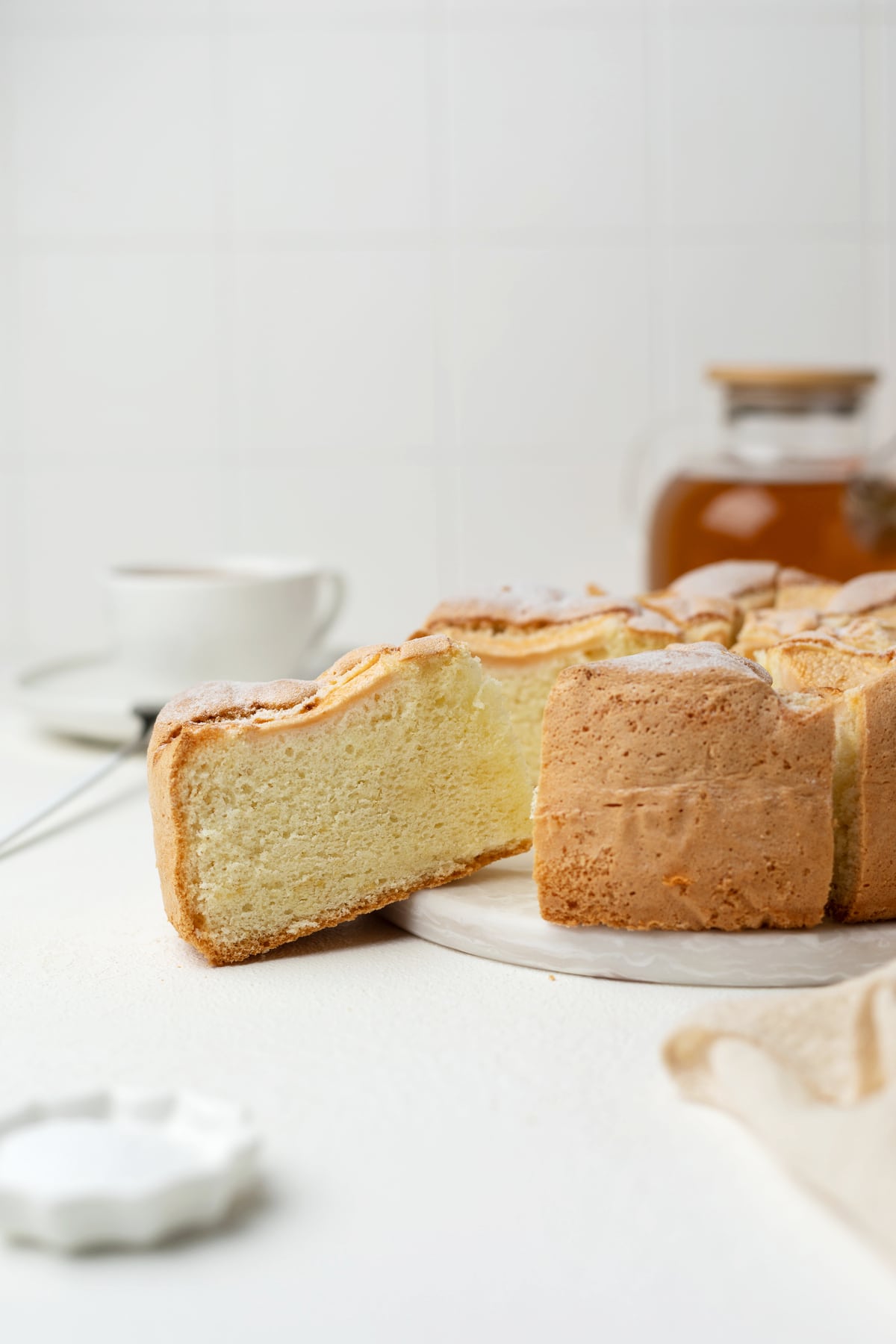 Sliced sponge apple cake on a serving platter.