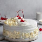 White forest cake on a cake board.